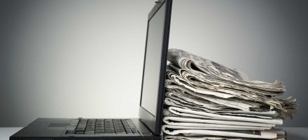 Laptop and Newspapers